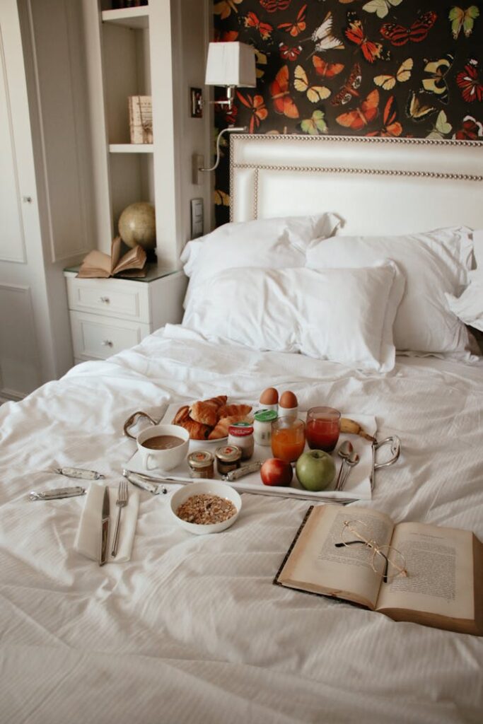 Demo Post 3 A cozy breakfast in bed with croissants, coffee, and a book in a stylish bedroom setting.